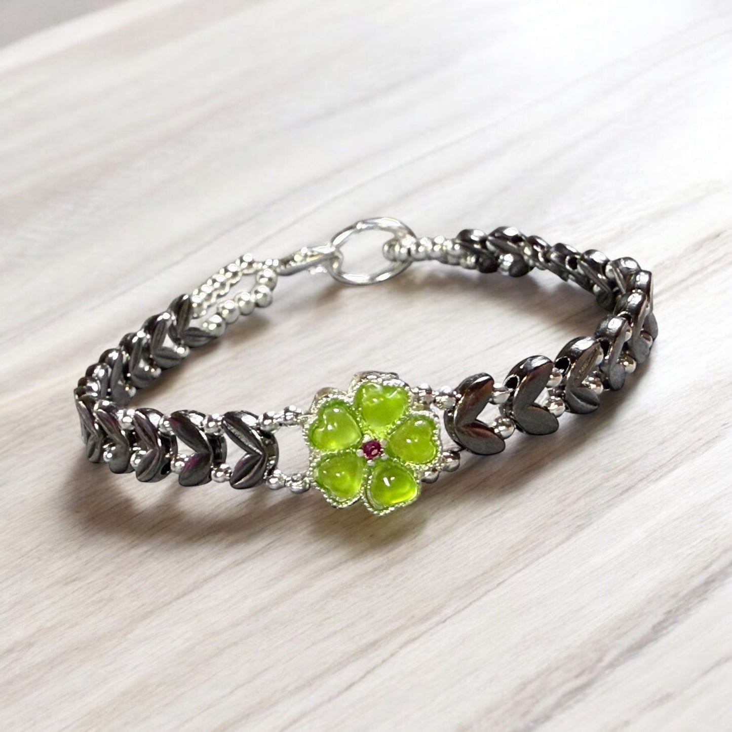 Black V shaped bracelet with green floral focal 7"