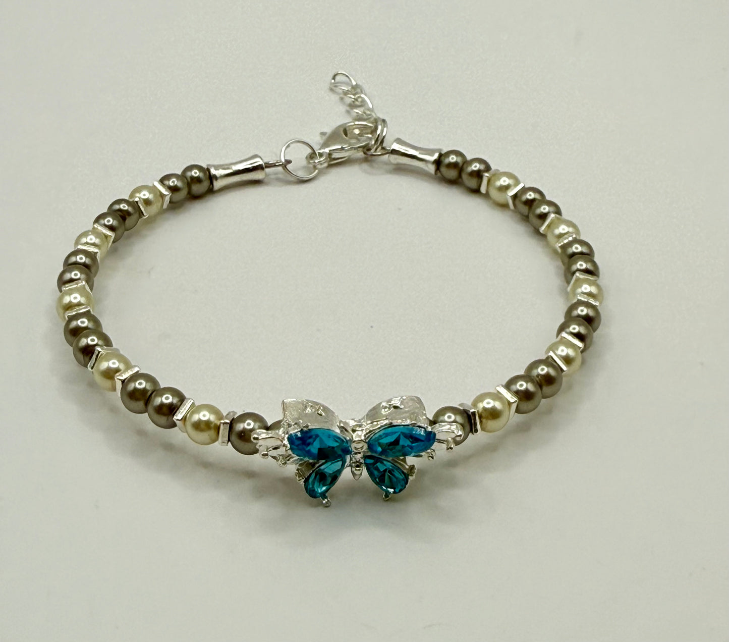 7.5” Ivory & Olive Glass Pearl Bracelet with Blue Butterfly Focal – Nature-Inspired Jewelry